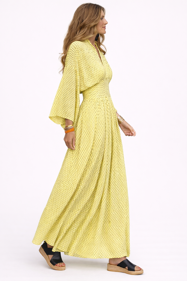 Woman wearing a yellow dress with a white background
